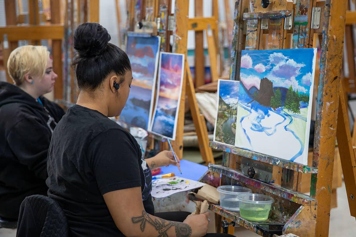 Student working on a painting